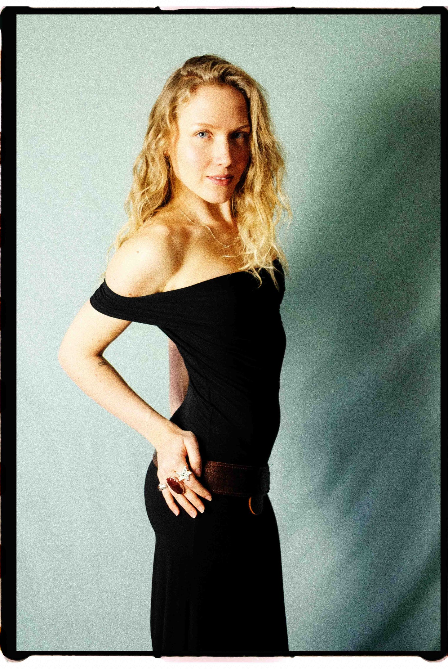 Marithé + François Girbaud 90s black bodycon midi dress styled on model, showing off-shoulder detail