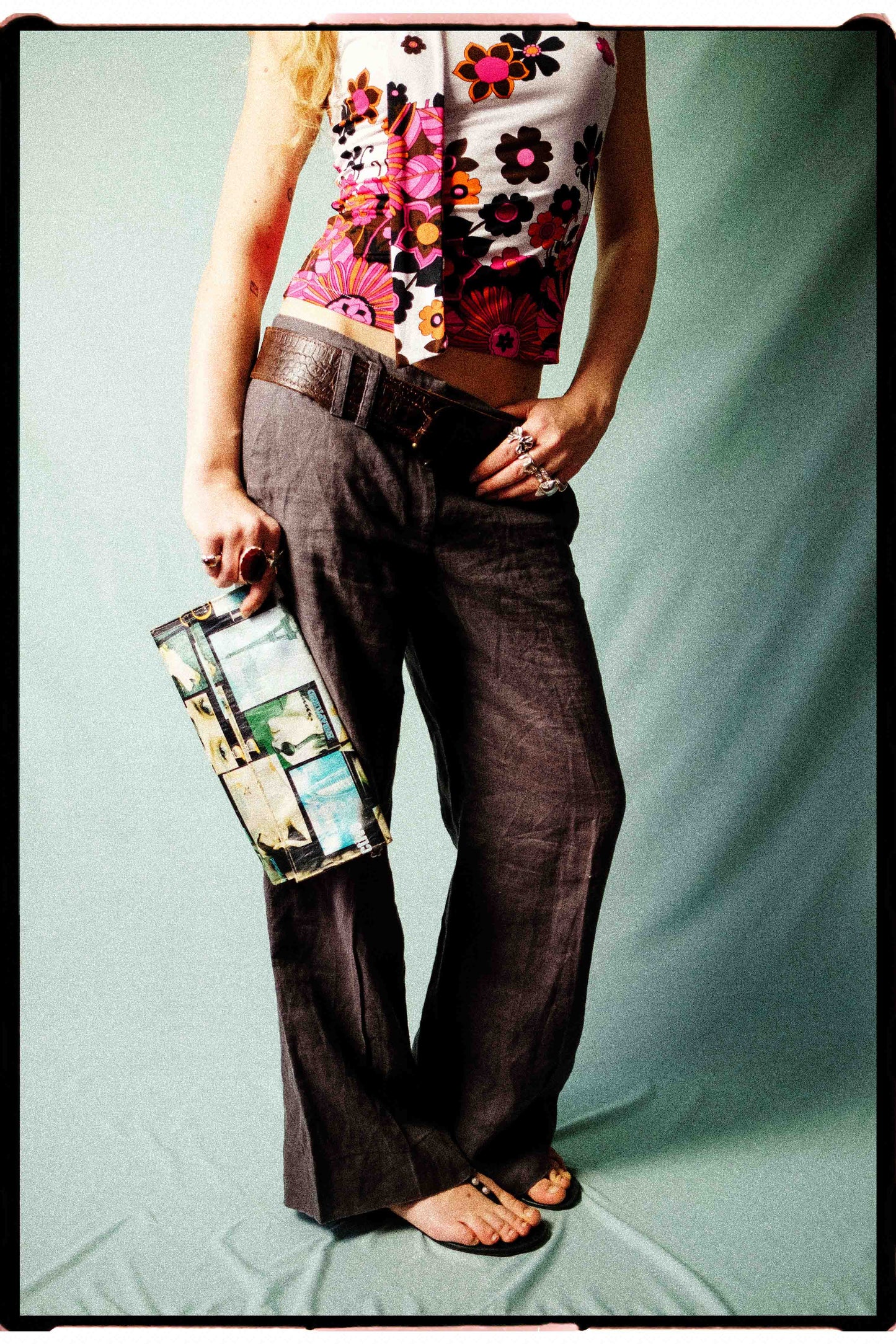 Close-up of taupe linen trousers showing front pockets and oversized belt loops, side view